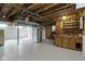 Unfinished basement with painted floor, utility equipment, and exposed wooden beams at 4640 Boulevard Pl, Indianapolis, IN 46208