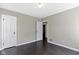 Bedroom with hardwood floors, featuring a door and neutral paint at 4640 Boulevard Pl, Indianapolis, IN 46208