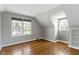Sunlit bedroom with hardwood floors, and large windows offering exterior views at 4640 Boulevard Pl, Indianapolis, IN 46208
