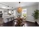 Cozy dining room area with a wooden table, stylish wicker pendant light, and views to the kitchen at 4640 Boulevard Pl, Indianapolis, IN 46208