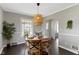 Charming dining room area with hardwood floors and a view to a brightly lit living room at 4640 Boulevard Pl, Indianapolis, IN 46208