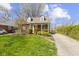 Charming home with lush landscaping and a driveway leading to the backyard at 4640 Boulevard Pl, Indianapolis, IN 46208