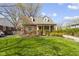 Charming red brick home with lush landscaping and a well-manicured lawn at 4640 Boulevard Pl, Indianapolis, IN 46208
