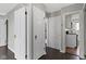 Hallway with hardwood floors, featuring multiple doors and neutral wall color at 4640 Boulevard Pl, Indianapolis, IN 46208