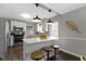 Bright eat-in kitchen with stainless steel appliances and a breakfast bar with pendant lighting at 4640 Boulevard Pl, Indianapolis, IN 46208