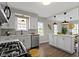 Bright kitchen with stainless steel appliances, white cabinets, and hardwood floors at 4640 Boulevard Pl, Indianapolis, IN 46208