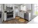 Kitchen with stainless steel appliances, white cabinets, and hardwood floors at 4640 Boulevard Pl, Indianapolis, IN 46208