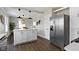 Kitchen with a white island, stainless steel appliances, hardwood floors, and neutral paint at 4640 Boulevard Pl, Indianapolis, IN 46208