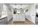 Kitchen with a white island, hardwood floors, and neutral paint at 4640 Boulevard Pl, Indianapolis, IN 46208