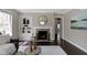Elegant living room with a fireplace, built-in shelving, and hardwood floors at 4640 Boulevard Pl, Indianapolis, IN 46208