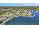 Beautiful aerial view showcasing waterfront homes with pristine lawns and the tree-lined lakefront at 4843 Snowberry Bay Ct, Carmel, IN 46033