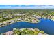 Expansive aerial view showcasing lakeside homes with private docks along a serene, tree-lined lake at 4843 Snowberry Bay Ct, Carmel, IN 46033