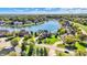 Luxury waterfront homes line a picturesque lake surrounded by lush greenery and mature trees at 4843 Snowberry Bay Ct, Carmel, IN 46033