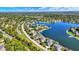 Stunning aerial view of lakeside homes, showing manicured lawns and private docks on a sunny day at 4843 Snowberry Bay Ct, Carmel, IN 46033