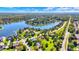 Overhead shot showcasing waterfront homes with docks and a serene lake surrounded by lush greenery at 4843 Snowberry Bay Ct, Carmel, IN 46033