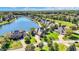 Luxury waterfront homes line a picturesque lake surrounded by lush greenery and mature trees at 4843 Snowberry Bay Ct, Carmel, IN 46033