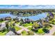 Luxury waterfront homes line a picturesque lake surrounded by lush greenery and mature trees at 4843 Snowberry Bay Ct, Carmel, IN 46033