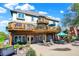 A beautiful backyard featuring a deck, a patio with an outdoor seating area, and landscaping at 4843 Snowberry Bay Ct, Carmel, IN 46033