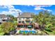 Large backyard features a swimming pool, upper-level wood deck, lower-level patio, and mature trees at 4843 Snowberry Bay Ct, Carmel, IN 46033