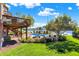 Lush backyard features a pool, deck, and beautiful landscaping with lake view at 4843 Snowberry Bay Ct, Carmel, IN 46033