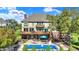 Large backyard features a swimming pool, upper-level wood deck, lower-level patio, and mature trees at 4843 Snowberry Bay Ct, Carmel, IN 46033