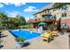 Inviting backyard with in-ground pool and multiple seating areas overlooking a lush green space at 4843 Snowberry Bay Ct, Carmel, IN 46033