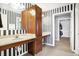 Bathroom featuring black and white stripe wallpaper and custom cherry wood vanity and cabinetry at 4843 Snowberry Bay Ct, Carmel, IN 46033