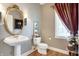 Traditional bathroom features pedestal sink, framed mirror, natural light, and classic fixtures at 4843 Snowberry Bay Ct, Carmel, IN 46033