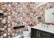 Stylish bathroom with floral wallpaper, dark vanity, updated fixtures, and thoughtful decor at 4843 Snowberry Bay Ct, Carmel, IN 46033