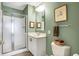 Practical bathroom with a shower, mirror, vanity, and toilet in neutral tones at 4843 Snowberry Bay Ct, Carmel, IN 46033