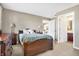 Comfortable bedroom showcases a wooden bed frame and matching furniture, creating a cozy retreat at 4843 Snowberry Bay Ct, Carmel, IN 46033
