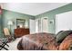 Bedroom featuring green walls, carpet, complemented by dresser and rocking chair at 4843 Snowberry Bay Ct, Carmel, IN 46033