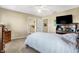 Carpeted bedroom with fan, dresser and TV, illuminated by natural light from two windows at 4843 Snowberry Bay Ct, Carmel, IN 46033