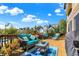 Relax on the spacious deck featuring comfortable seating, charming decor, and scenic views of the tranquil lake beyond at 4843 Snowberry Bay Ct, Carmel, IN 46033