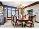 Formal dining room featuring an elegant chandelier, large window, and a classic dining set at 4843 Snowberry Bay Ct, Carmel, IN 46033