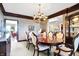Formal dining room featuring a wood table, chandelier, and elegant wallpaper at 4843 Snowberry Bay Ct, Carmel, IN 46033