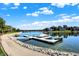 A view of a covered boat on a boat dock near a paved walking path on a sunny day at 4843 Snowberry Bay Ct, Carmel, IN 46033