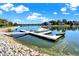 Dock with covered boat, surrounded by clear water reflecting the blue sky and clouds at 4843 Snowberry Bay Ct, Carmel, IN 46033