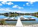 Long white docks and a covered boat reflecting in the water on a sunny, clear day at 4843 Snowberry Bay Ct, Carmel, IN 46033