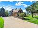 A two-car garage connects with a brick home that boasts a long driveway and manicured landscaping at 4843 Snowberry Bay Ct, Carmel, IN 46033