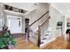 Inviting foyer with hardwood floors, staircase, and white trim, offering a warm welcome at 4843 Snowberry Bay Ct, Carmel, IN 46033
