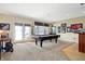 Bright game room with natural light features a full-size pool table and a built-in bar area at 4843 Snowberry Bay Ct, Carmel, IN 46033