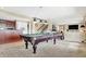 Finished basement showcases a well-lit carpeted game room with pool table, bar, and stairs at 4843 Snowberry Bay Ct, Carmel, IN 46033