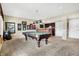 Spacious game room boasts a billiard table, with an adjacent bar and built-in cabinets at 4843 Snowberry Bay Ct, Carmel, IN 46033