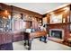 Classic home office with wood built-ins, a unique desk, and a fireplace for a cozy workspace at 4843 Snowberry Bay Ct, Carmel, IN 46033