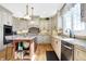 Bright kitchen featuring stone countertops, stainless appliances, central island with bar stool seating, and wooden floors at 4843 Snowberry Bay Ct, Carmel, IN 46033
