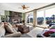 Bright living room featuring a fireplace, ceiling fan, and sliding glass doors to the deck at 4843 Snowberry Bay Ct, Carmel, IN 46033