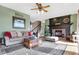 Cozy living room with a fireplace, ceiling fan, and comfortable seating at 4843 Snowberry Bay Ct, Carmel, IN 46033