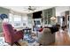 Cozy living room with a fireplace, hardwood floors, and comfortable seating with a view at 4843 Snowberry Bay Ct, Carmel, IN 46033