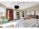 Bright main bedroom featuring a tray ceiling, large window and private ensuite bathroom at 4843 Snowberry Bay Ct, Carmel, IN 46033